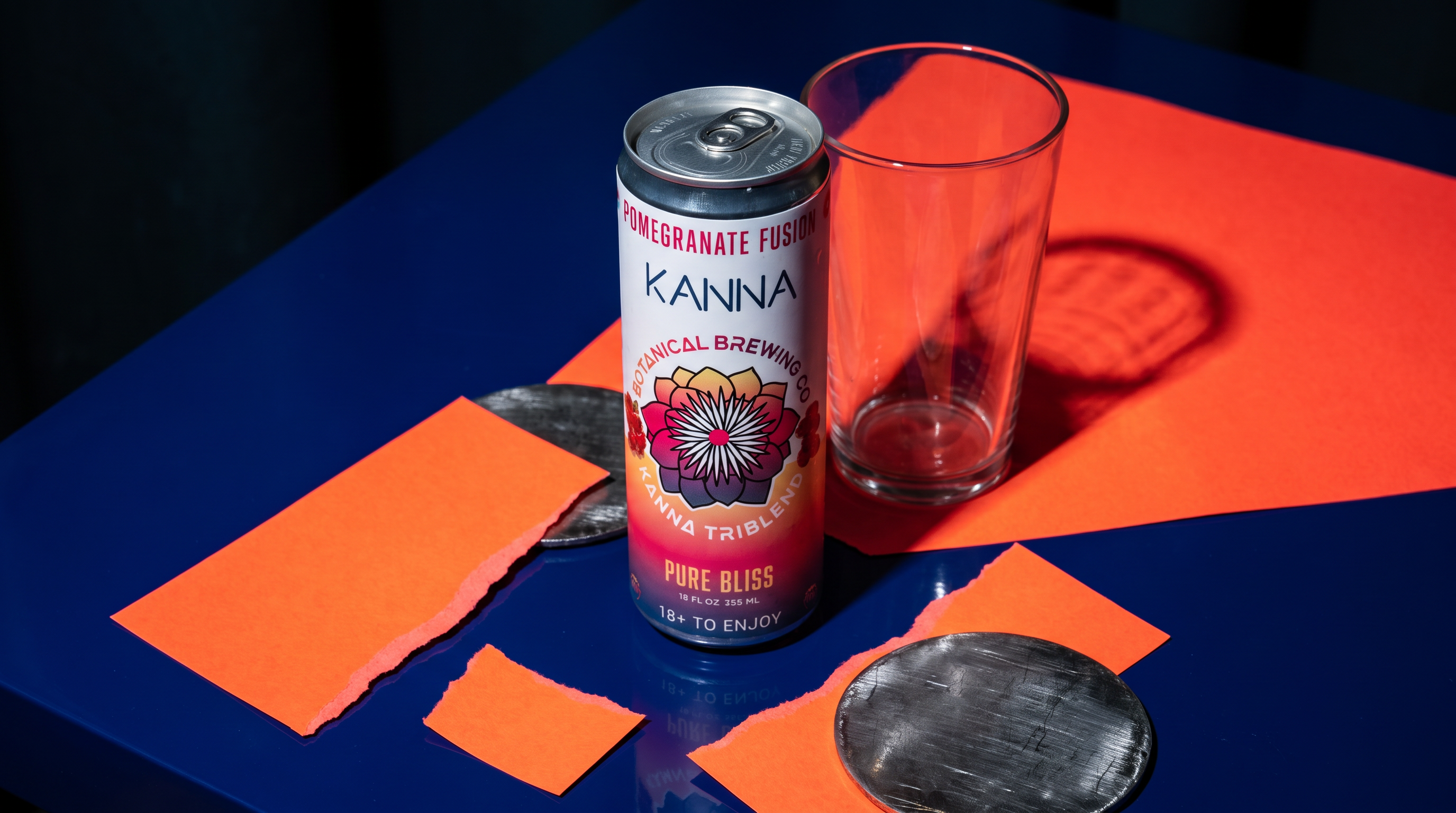 Kanna Pomegranate Fusion can at a late table with a glass and orange place setting